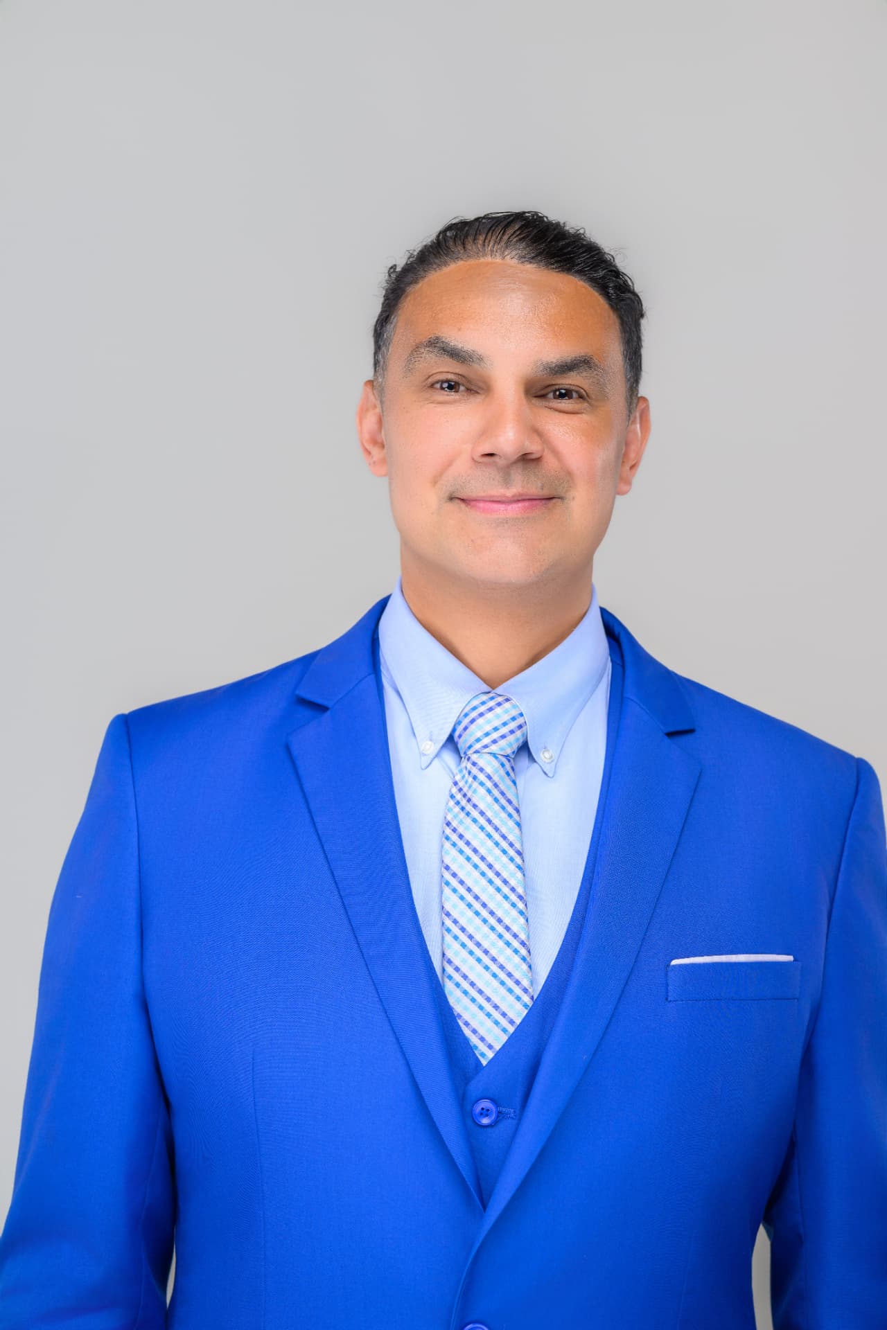 Angel Alba, Massachusetts event DJ, in a royal blue three-piece suit