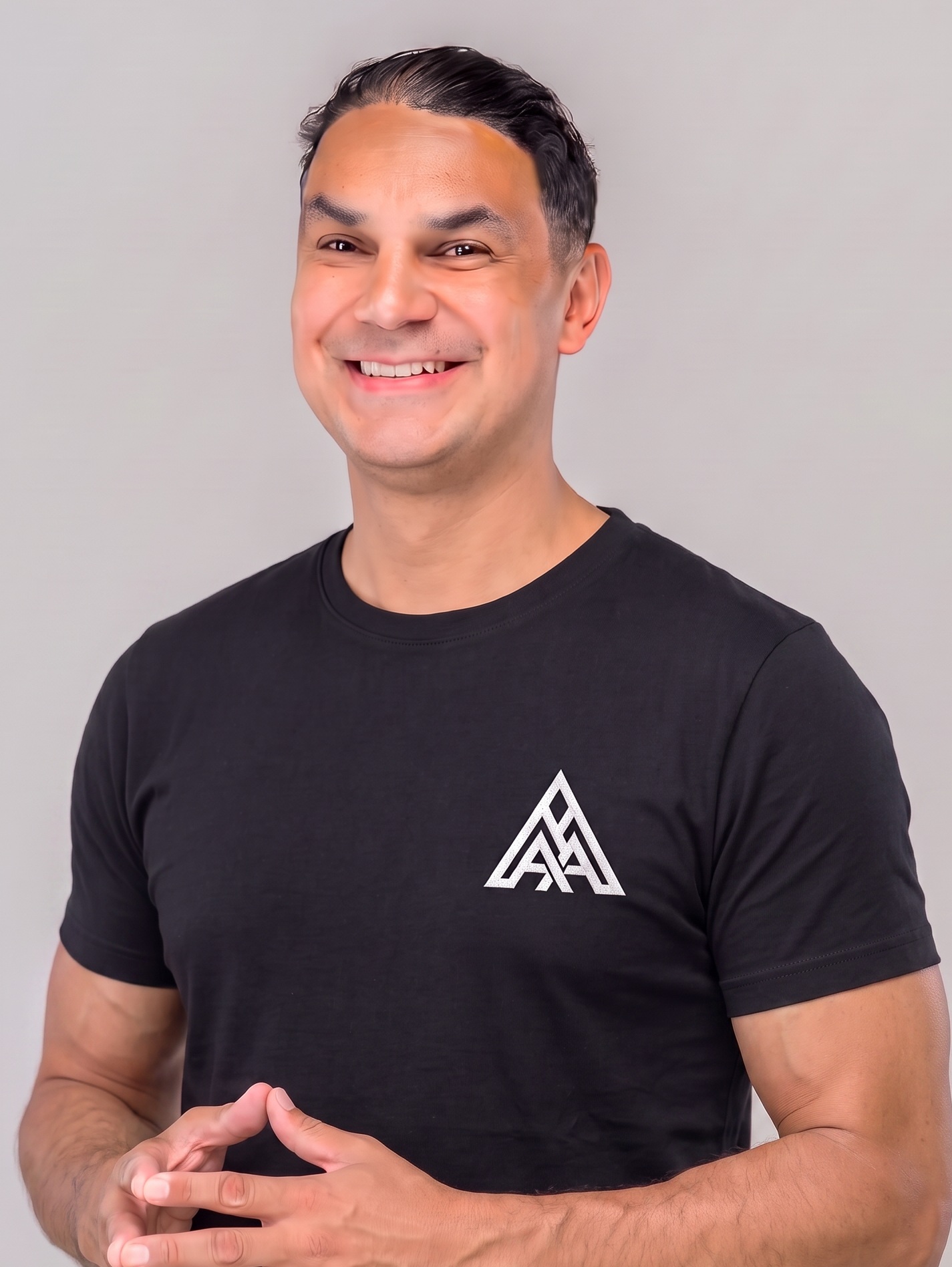 DJ Angel Alba, New England wedding and corporate DJ, in a black AA monogram tee ready to mix behind the DJ booth